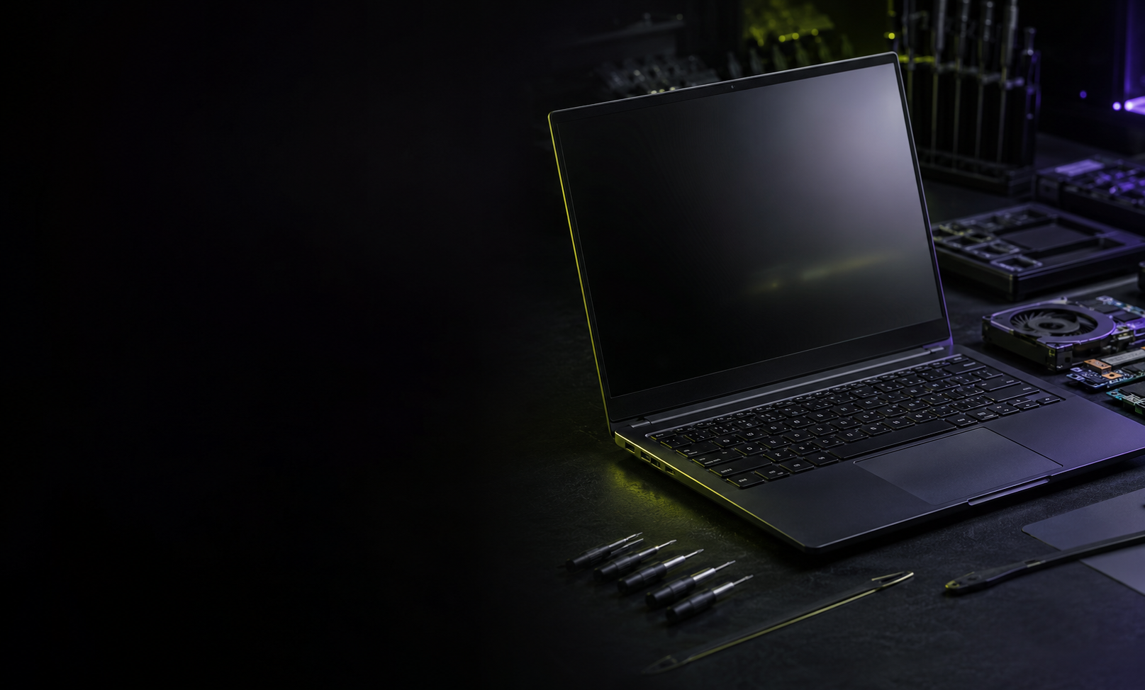 Black laptop on a professional repair workbench with precision tools